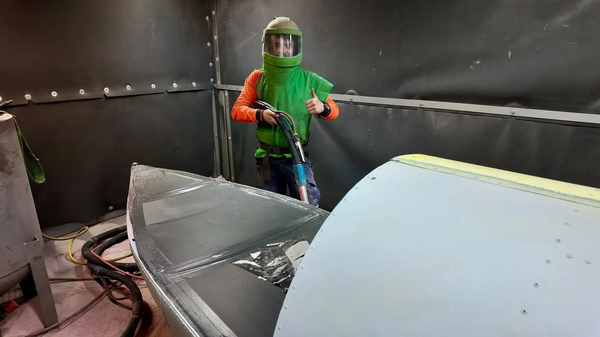 A&B Coatings operator preparing a component inside the sandblasting booth